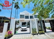 Nhà 2 tầng thiết kế hiện đại   có sân đỗ xe và phía sau là sân...